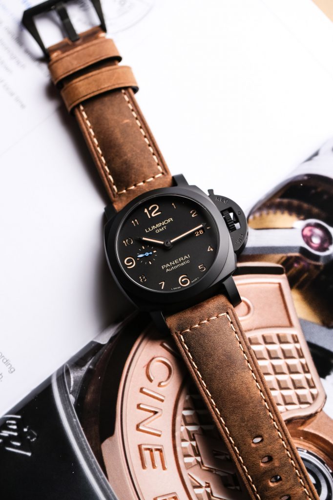 The black dial fake watch has brown strap.